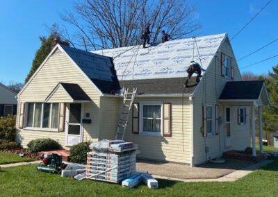3 men working on the foundation for new shingles